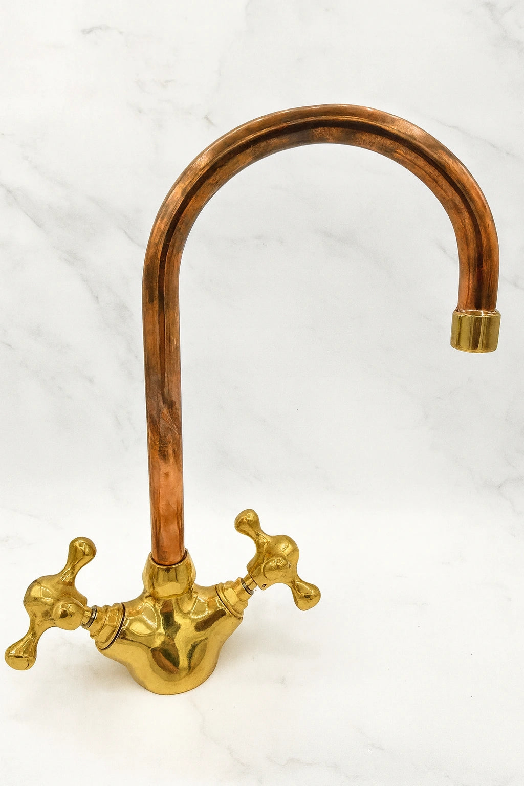 Copper and gold kitchen faucet on a white background