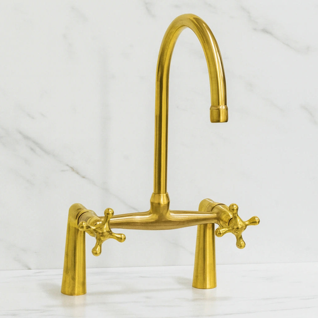brass kitchen faucet on a white background