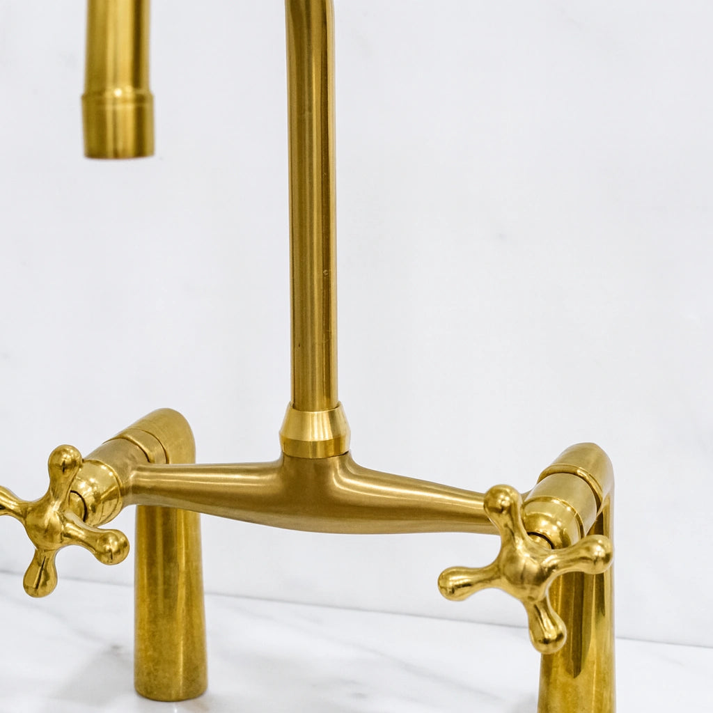 Brass kitchen faucet on a white background