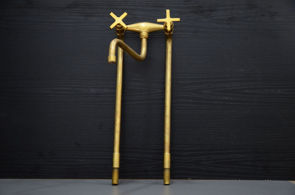 Gold faucet sculpture on a black background