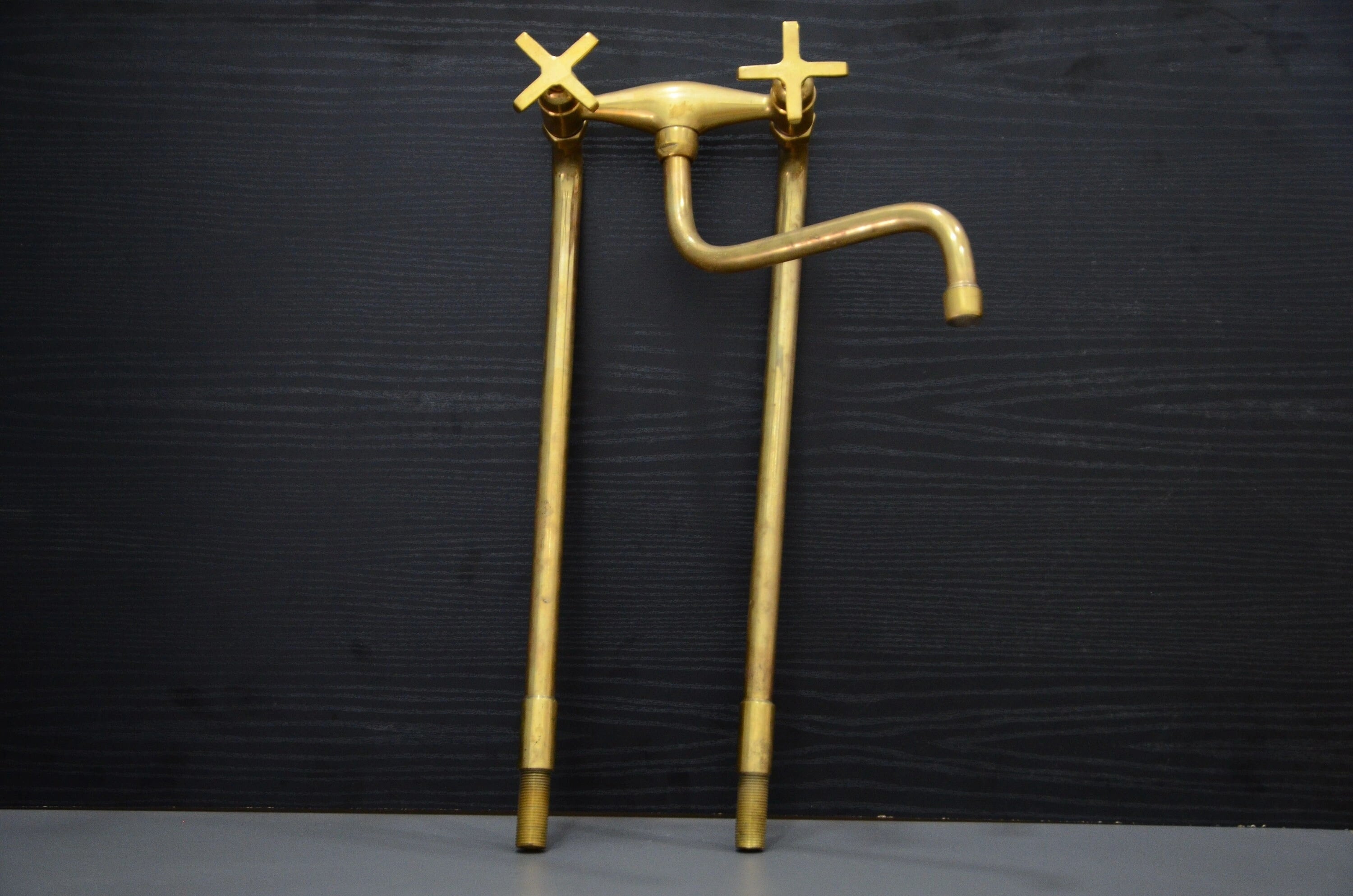 Gold faucet and pipes on a black background