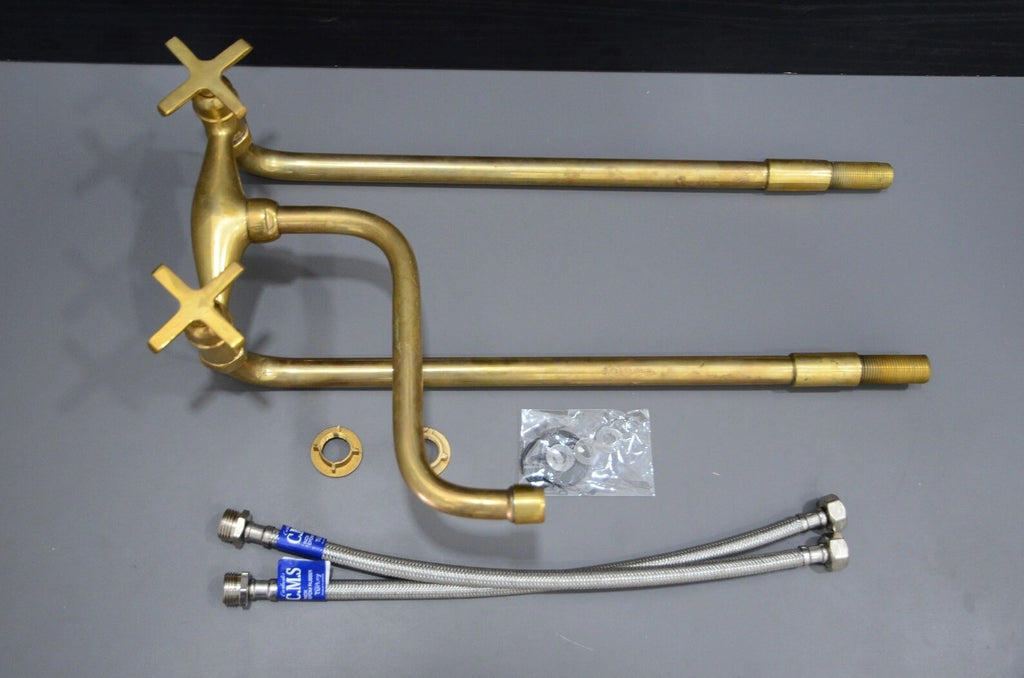 Brass plumbing components on a gray background